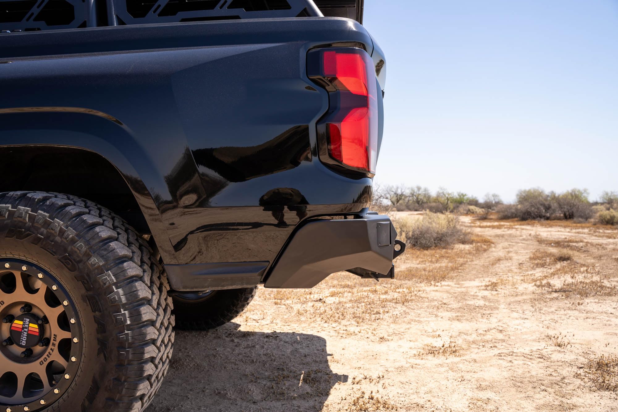 Rear Bumper DV8 Offroad Spec Series for 2023-2024 Chevy Colorado & GMC Canyon | Two 3" Pod Light Mounts | Integrated D-Ring Mounts | Retains Blind Spot Monitoring & Sensors | Powder Coated | Steel