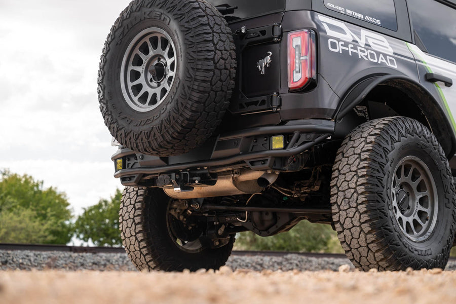 Rear Tube Bumper DV8 Offroad for 2021-2025 Ford Bronco | Sleek Prerunner Type Design | (2) 3" Pod Light Mounts | Durable Steel Construction | Micro-Texture Powder Coated Finish | Fully Bolt-On Design