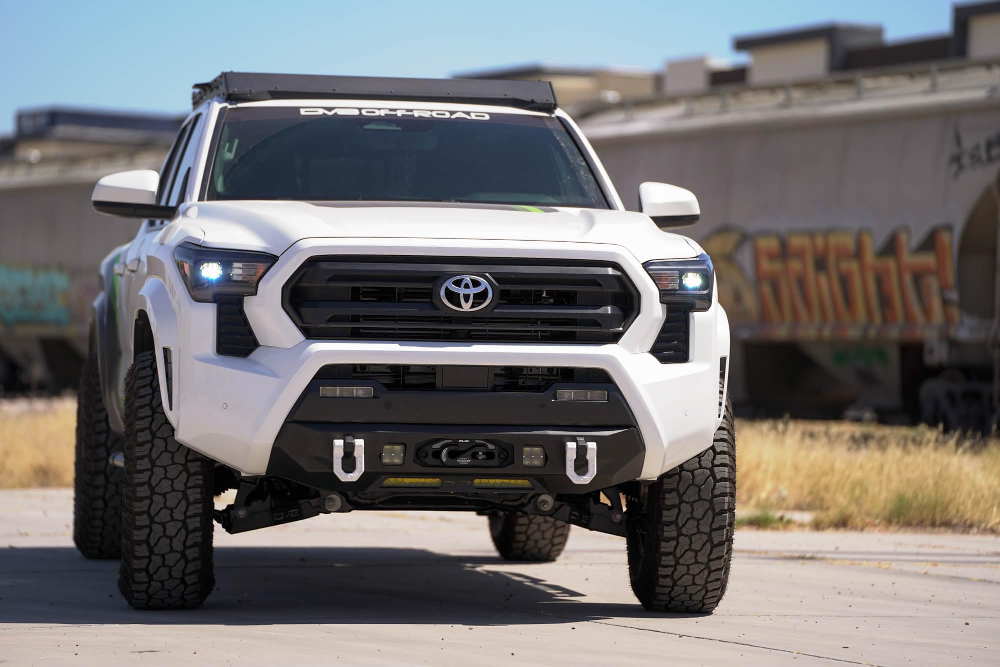 Front Bumper DV8 Centric for 2024 Toyota Tacoma | One 20-Inch Single Row Light Bar & Two 3-Inch Pod Light Mounts | Integrated Standard Winch & D-Ring Mounts | Micro-Texture Black Powder Coat Finish