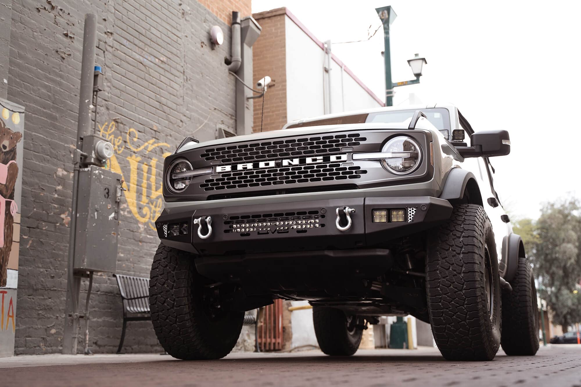 OE Plus Series DV8 Offroad Front Bumper Compatible with 2021-2025 Ford Bronco | Multiple Light Mounts | Compatible with OEM Skid Plate, 360° Camera, & Sensors | Reinforced D-Ring Mounts