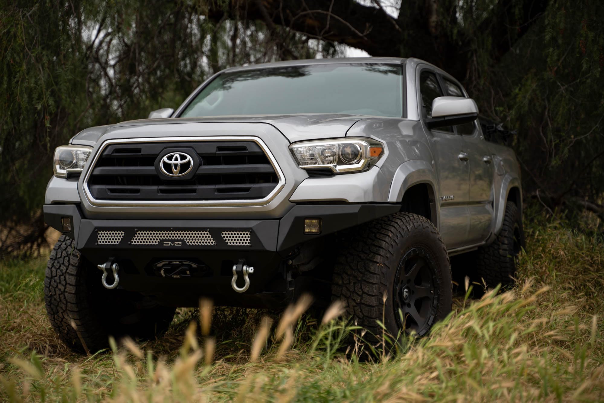 Winch Front Bumper DV8 MTO Series for 2016-2023 Toyota Tacoma | High Clearance Fitment | Mounts up to a 12,000lb Rated Winch | Integrated Light Bar and Pod Light Mounts | Black Powder Coat Finish