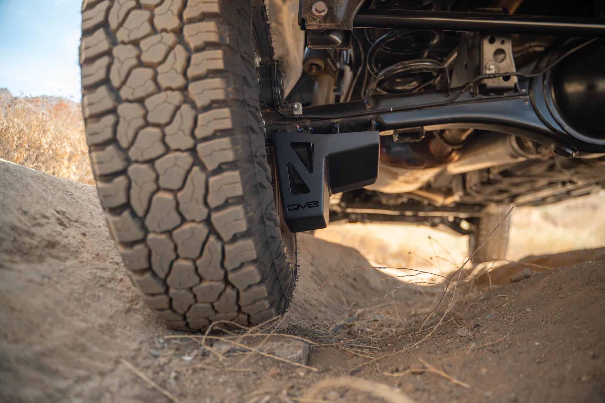 Rear Shock & Link Skid Plates DV8 for 2024 Toyota Tacoma | Protects Lower Shock Mount & Link | Built-in Drain Holes | Single Piece Design | Fully Bolt-On Installation | Black Powder Coat | 4mm Steel