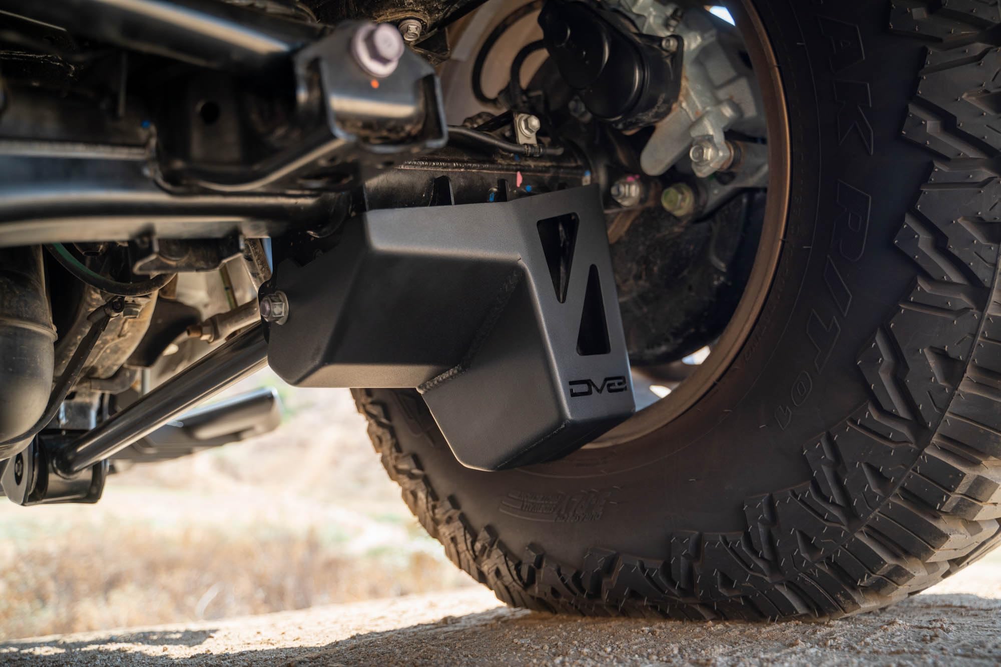 Rear Shock & Link Skid Plates DV8 for 2024 Toyota Tacoma | Protects Lower Shock Mount & Link | Built-in Drain Holes | Single Piece Design | Fully Bolt-On Installation | Black Powder Coat | 4mm Steel