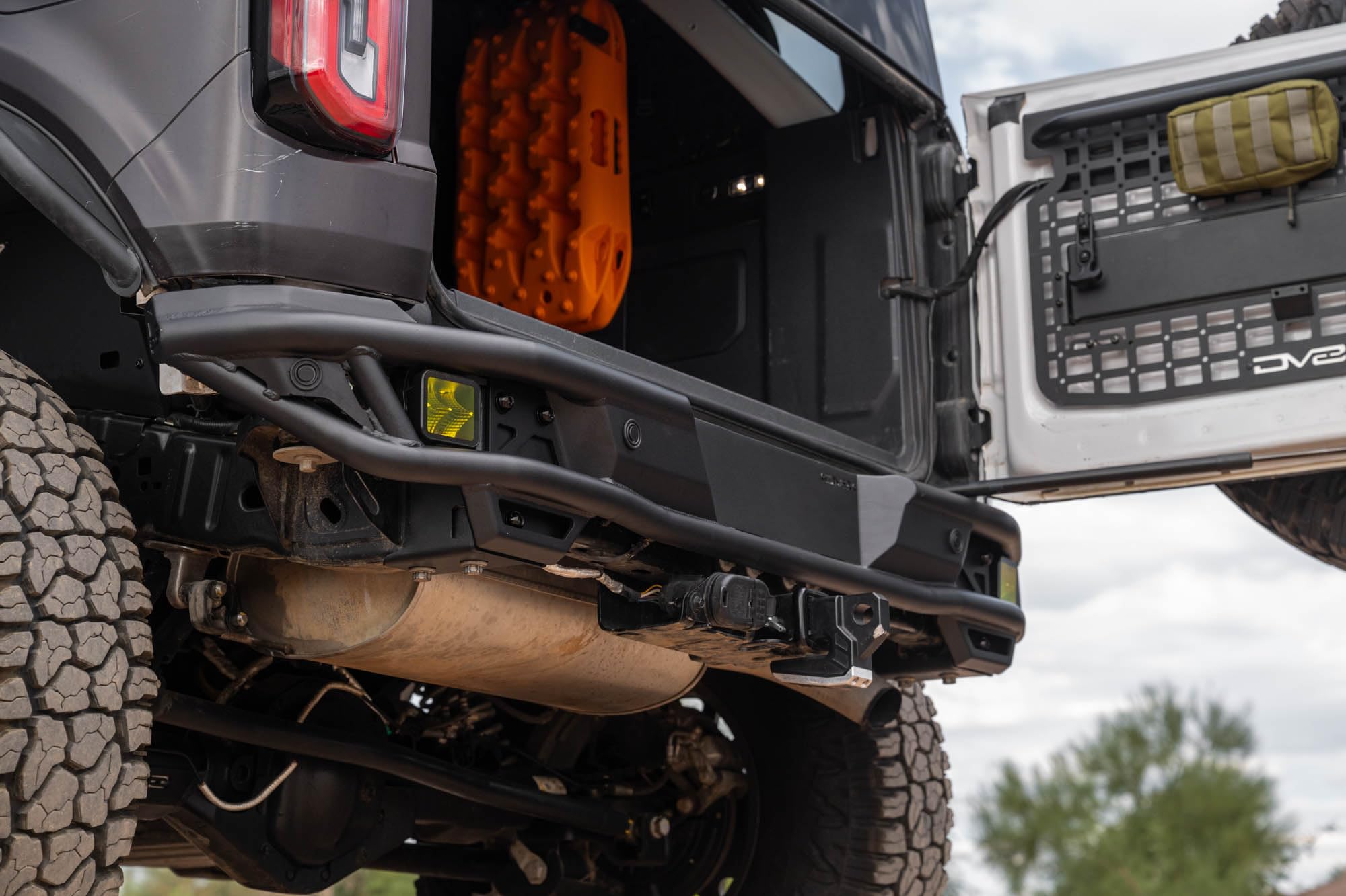 Rear Tube Bumper DV8 Offroad for 2021-2025 Ford Bronco | Sleek Prerunner Type Design | (2) 3" Pod Light Mounts | Durable Steel Construction | Micro-Texture Powder Coated Finish | Fully Bolt-On Design