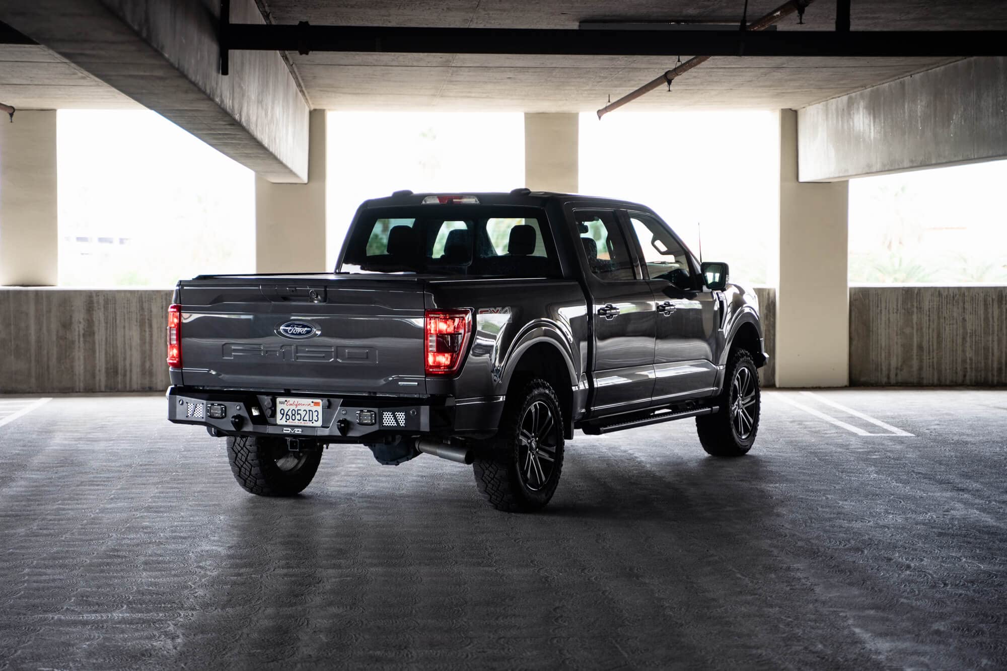MTO Series DV8 Offroad Rear Bumper for 2021-2025 Ford F-150 | Utility Steps | Designed for Single Exhaust Setups | Accepts (2) 3" Flush Mount Pod Lights | Paintable Aluminum Inserts
