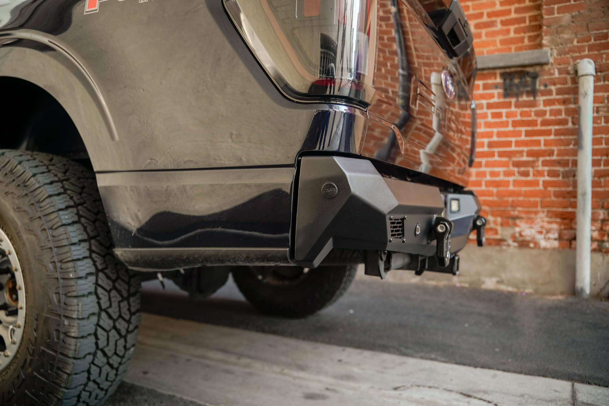 Rear Bumper DV8 Offroad Spec Series for 2021-2025 Ford F-150 | Full-Width Design | (2) 3" Pod Light Mounts | Pair of 1" D-Ring Mounts | Micro-Texture Black Powder Coat Finish | Steel Construction