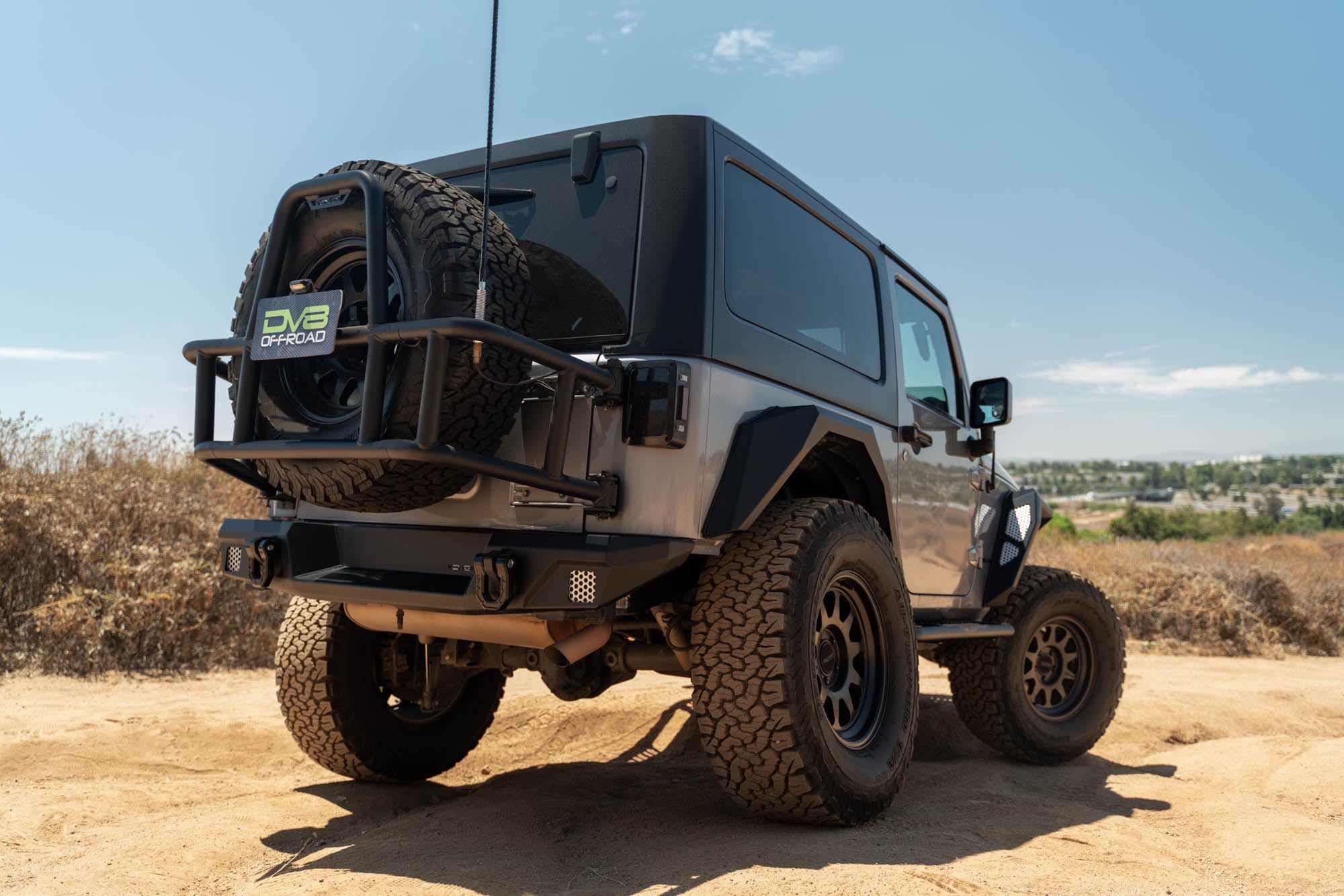 Tire Carrier Body Mounted for 2007-2018 Jeep Wrangler JK | Improves Departure Angle | Transfers Weight from The Door Hinges to The Vehicle Body | LED License Plate Light | 2 Whip Flag/Antenna Mounts