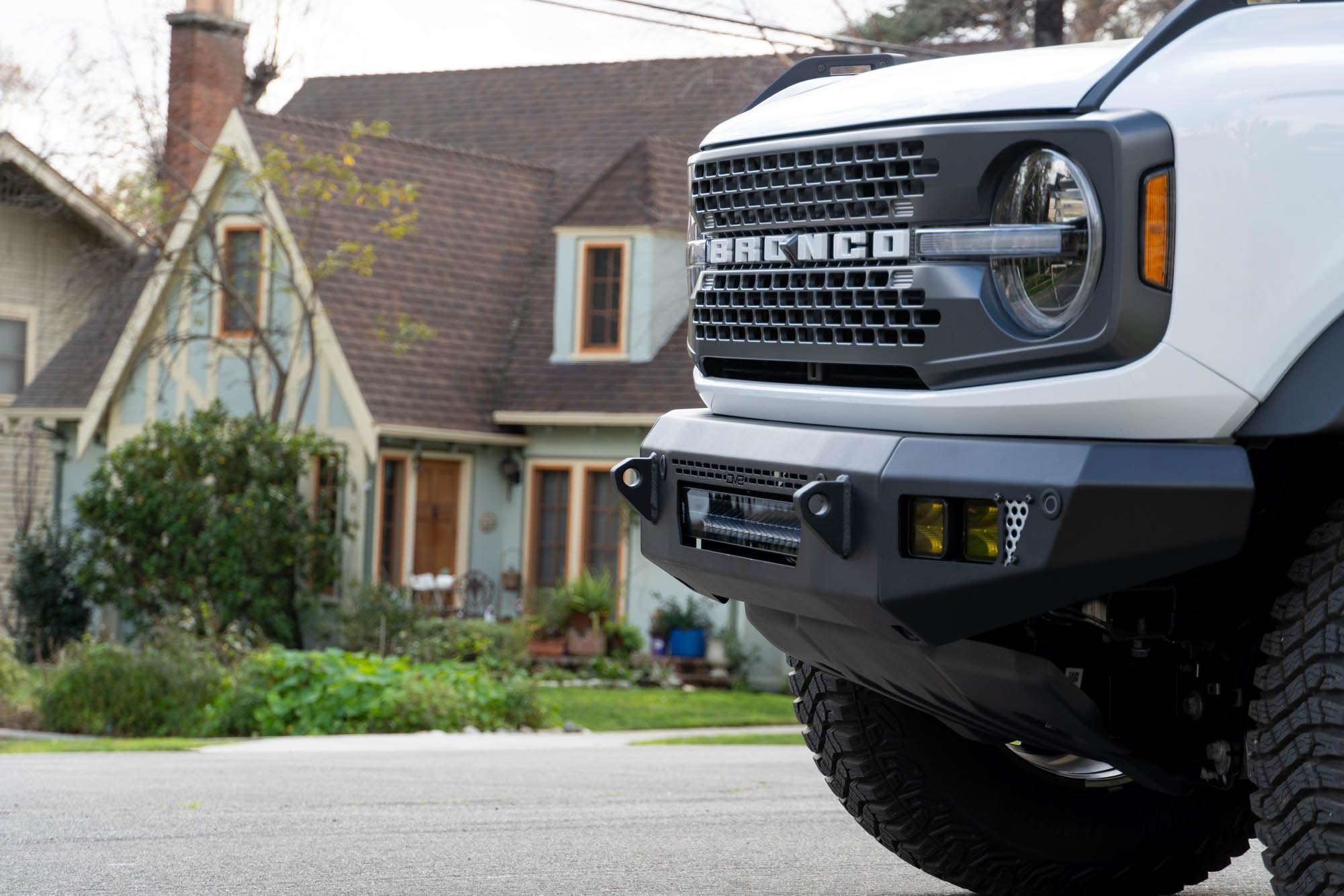 OE Plus Series V2 DV8 Offroad Front Bumper for 2021-2025 Ford Bronco | Low-Profile OE Style Design | Mounts One 20" Light Bar | Mounts Four 3" Pod Lights | Retains Adaptive Cruise Control