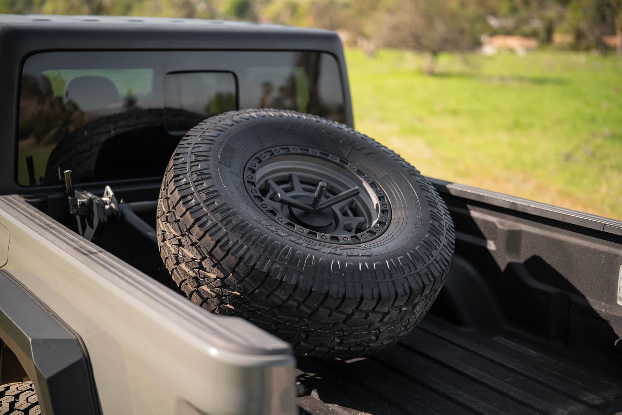 DV8 Offroad Spare Tire Carrier Adjustable in-Bed for 2020-2025 Jeep Gladiator JT | Flat or Angled Mounting Positions | Stainless Single Action Latching Mechanism | Compatible w/Most Wheel/Tire Setups