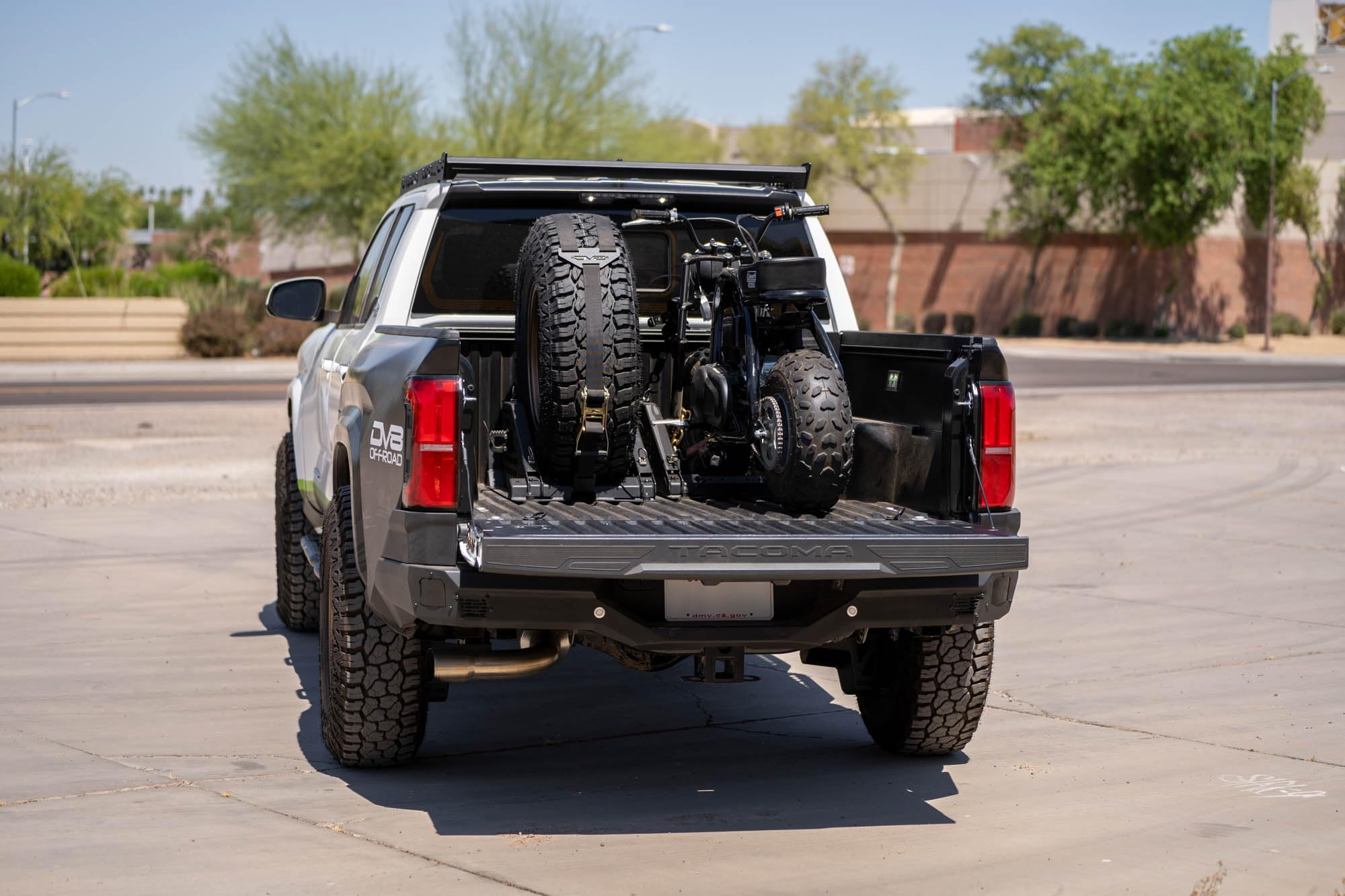 Offroad DV8 Truck Bed Universal Tire Carrier & Accessory Mount | Featured Side Molle Panels for Mounting Gear & Supplies | Adjustable for Carrying Various Sized Tires and Bikes | Powder Coated Finish