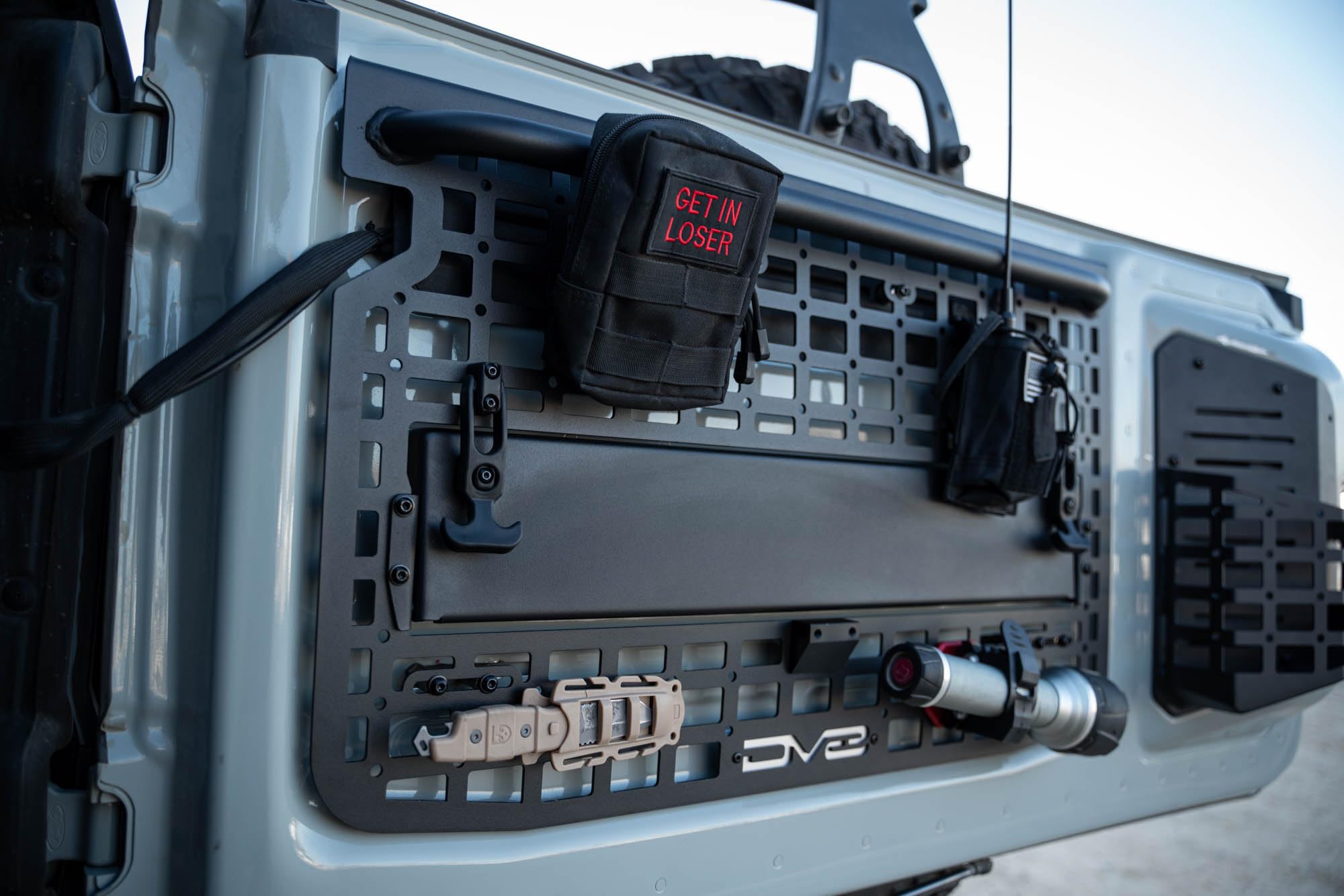 Tailgate Molle Panel DV8 Offroad for The 2021-2025 Ford Bronco | Perfect for Molle Bags, Knife Sheaths, Med Kits, Recovery Gear & More | Drop-Down Tray for Holding Drinks & Other Gear While at Camp