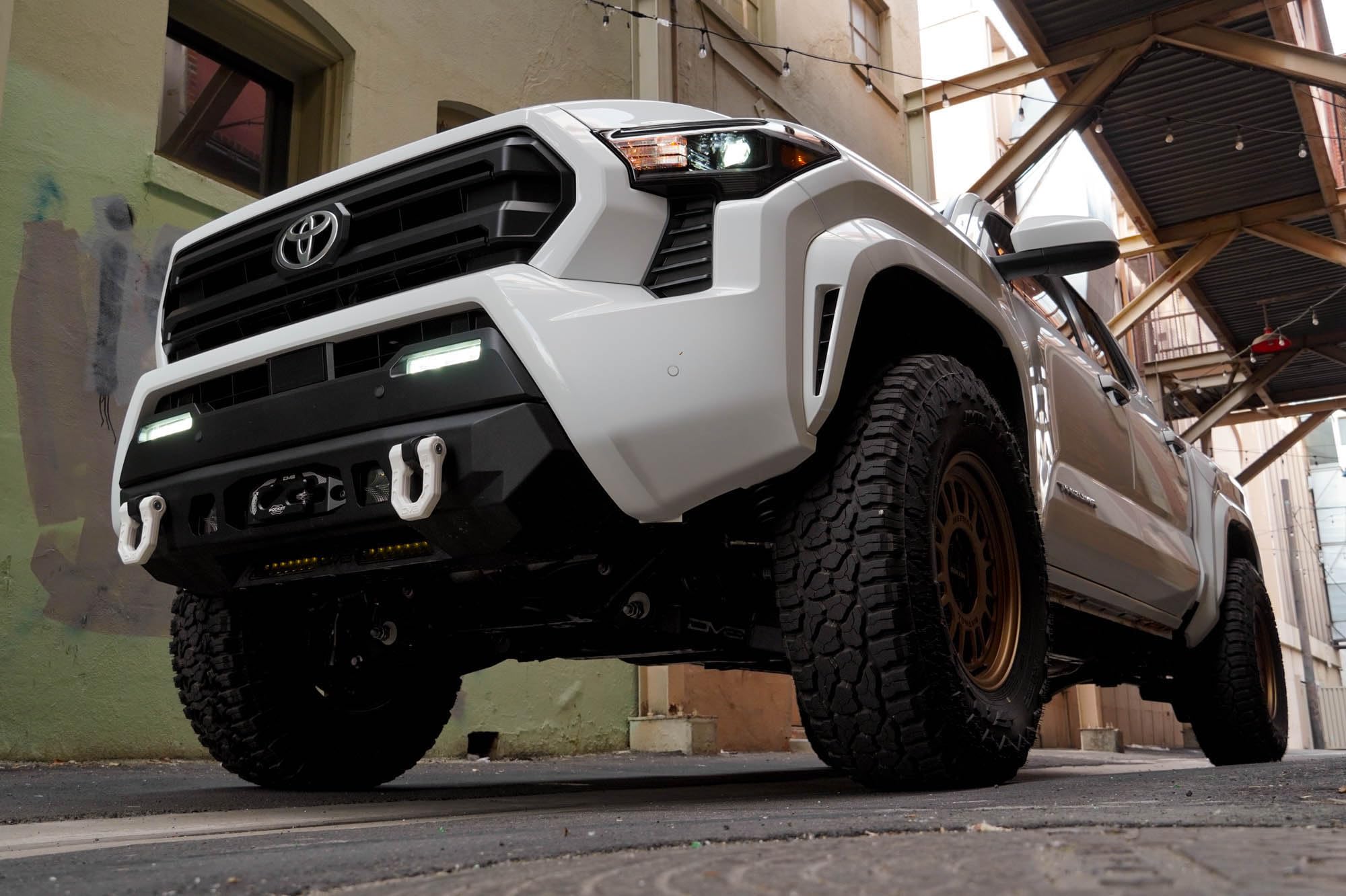Front Bumper DV8 Centric for 2024 Toyota Tacoma | One 20-Inch Single Row Light Bar & Two 3-Inch Pod Light Mounts | Integrated Standard Winch & D-Ring Mounts | Micro-Texture Black Powder Coat Finish