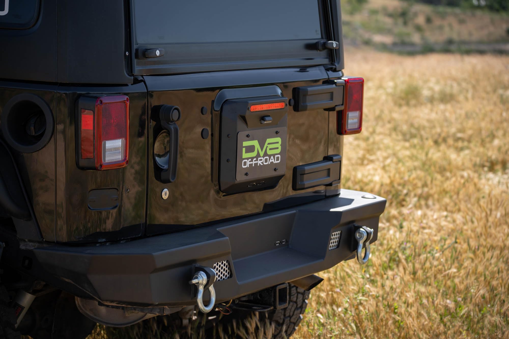 Spare Tire Delete DV8 Offroad for 2007-2018 Jeep Wrangler JK | Replaces Spare Tire Assembly | Maximizes Departure Angle | Features LED License Plate Light | Included Rubber Plugs
