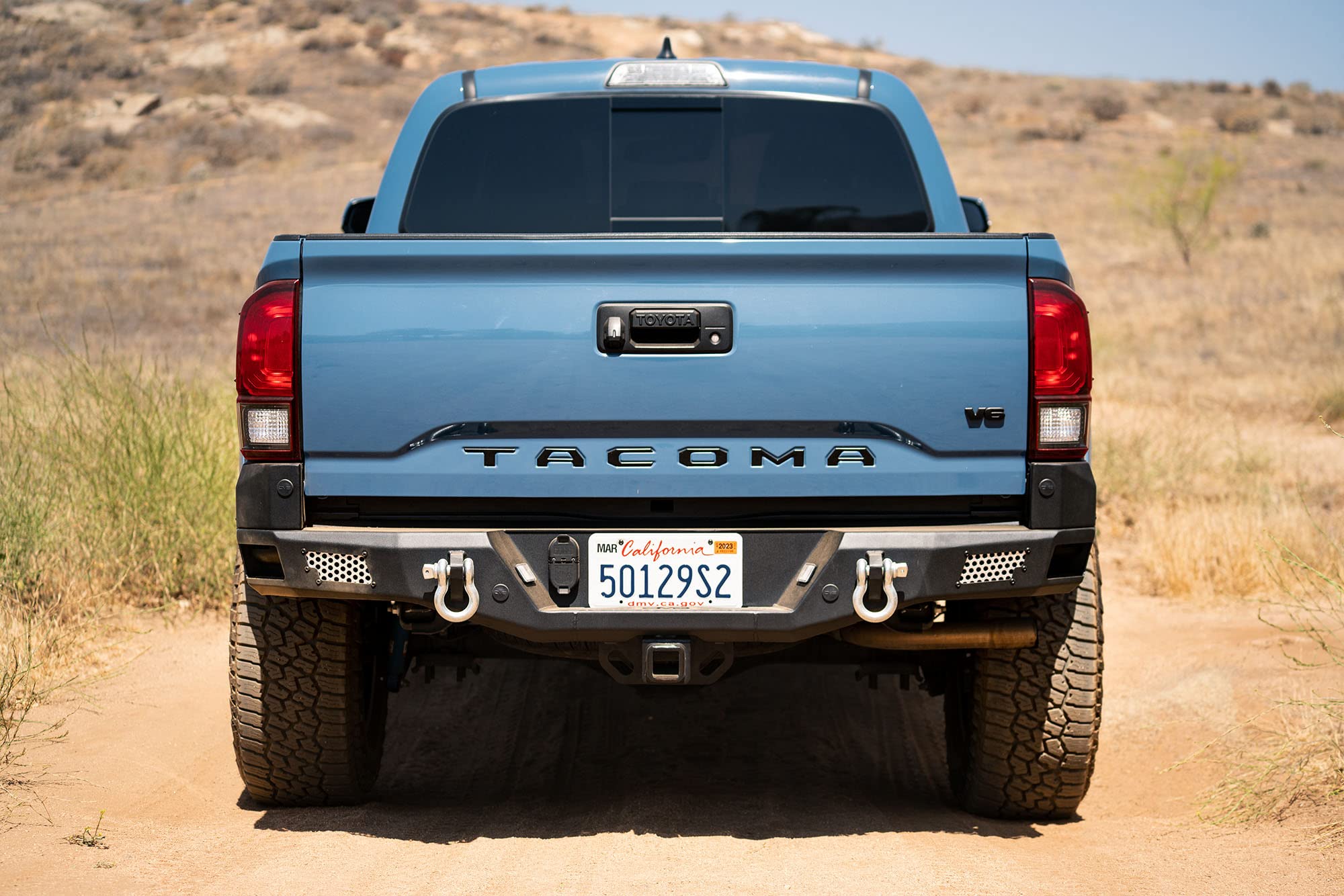 MTO Series Rear Bumper for Tacoma 2016 - Current | DV8 Offroad | Corner Side Steps | Auxiliary Light Mounts | Paintable Mesh Panels | Works with Sensors | Compatible with OEM Tow Package | RBTT1-04