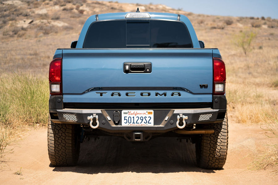 MTO Series Rear Bumper for Tacoma 2016 - Current | DV8 Offroad | Corner Side Steps | Auxiliary Light Mounts | Paintable Mesh Panels | Works with Sensors | Compatible with OEM Tow Package | RBTT1-04