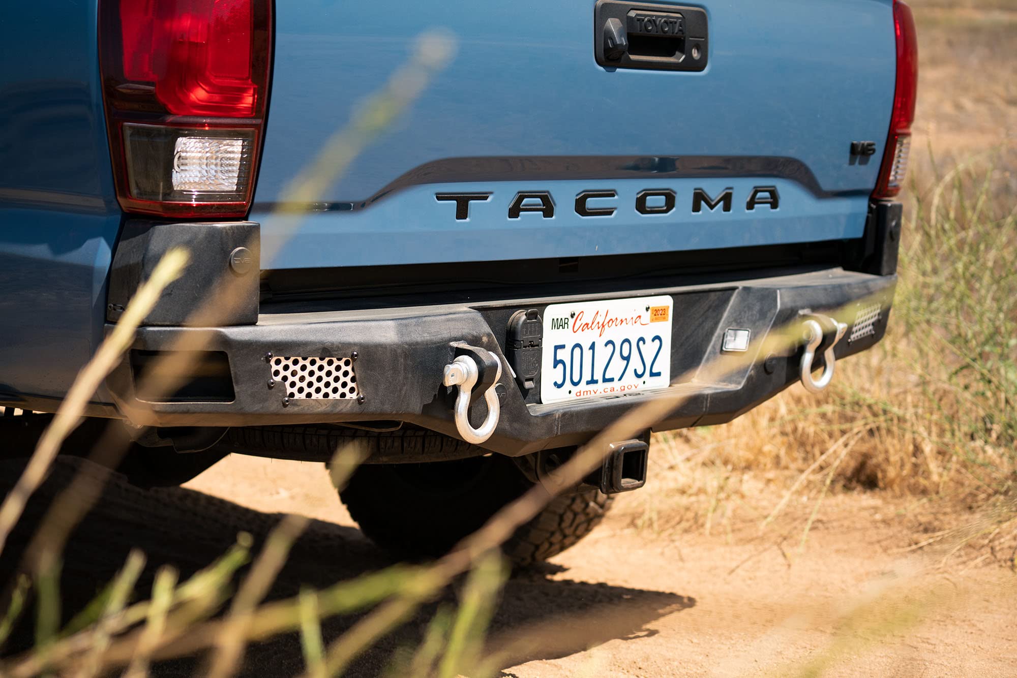 MTO Series Rear Bumper for Tacoma 2016 - Current | DV8 Offroad | Corner Side Steps | Auxiliary Light Mounts | Paintable Mesh Panels | Works with Sensors | Compatible with OEM Tow Package | RBTT1-04