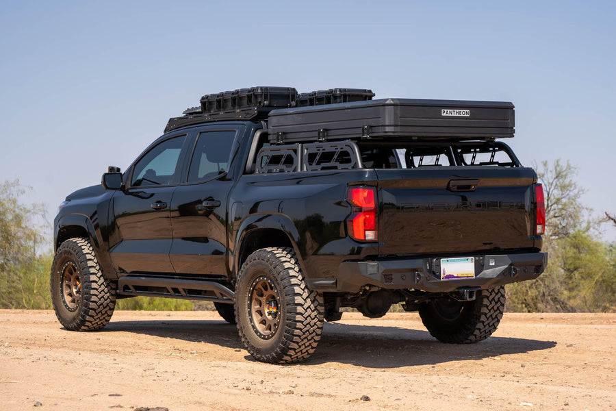 Rear Bumper DV8 Offroad Spec Series for 2023-2024 Chevy Colorado & GMC Canyon | Two 3" Pod Light Mounts | Integrated D-Ring Mounts | Retains Blind Spot Monitoring & Sensors | Powder Coated | Steel
