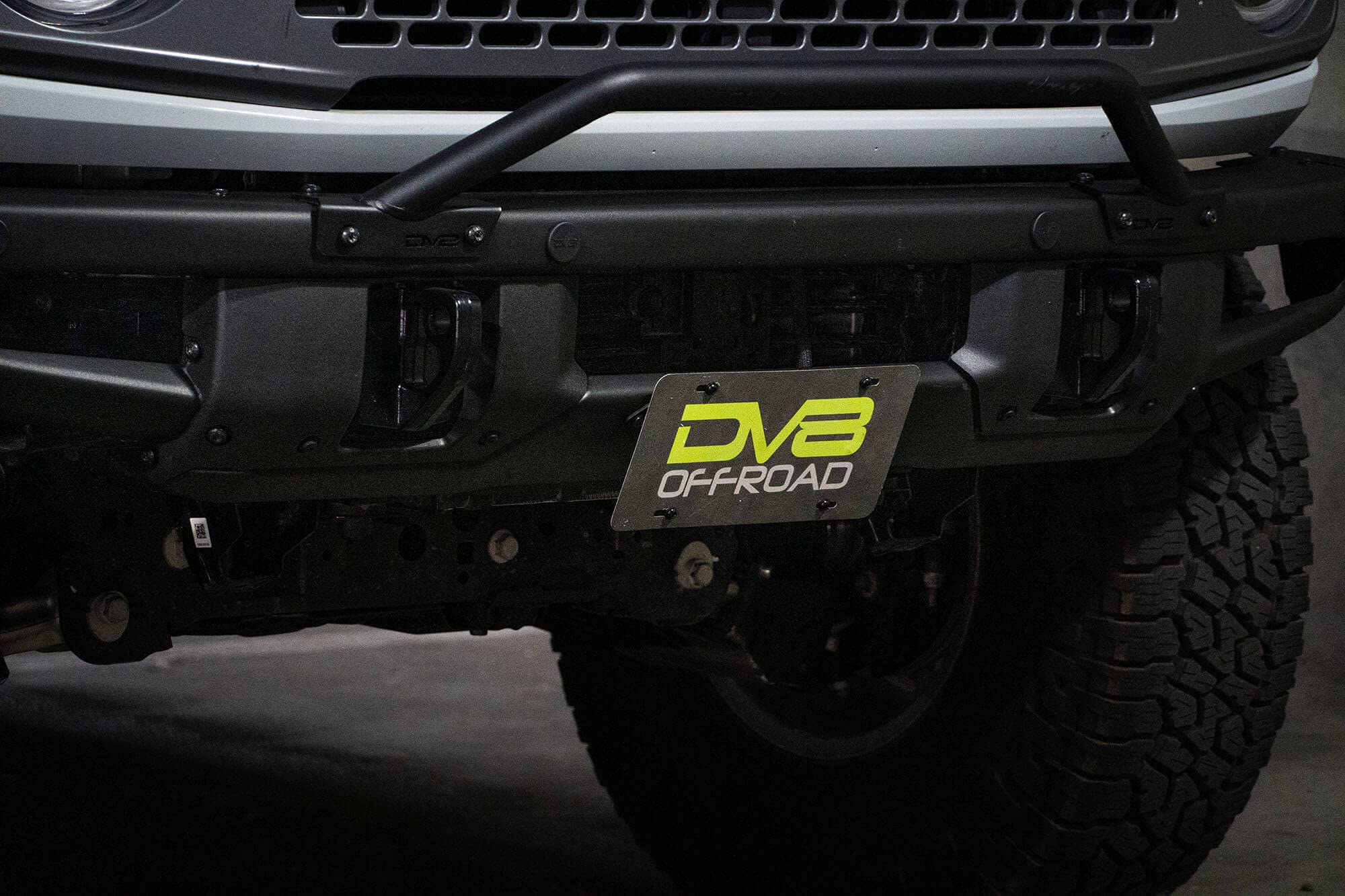 License Plate Relocation Bracket DV8 Offroad for 2021-2024 Ford Bronco | OEM Steel Front Bumper | Lower Center Mount | Keeps Grille Open | Quick & Easy Installation