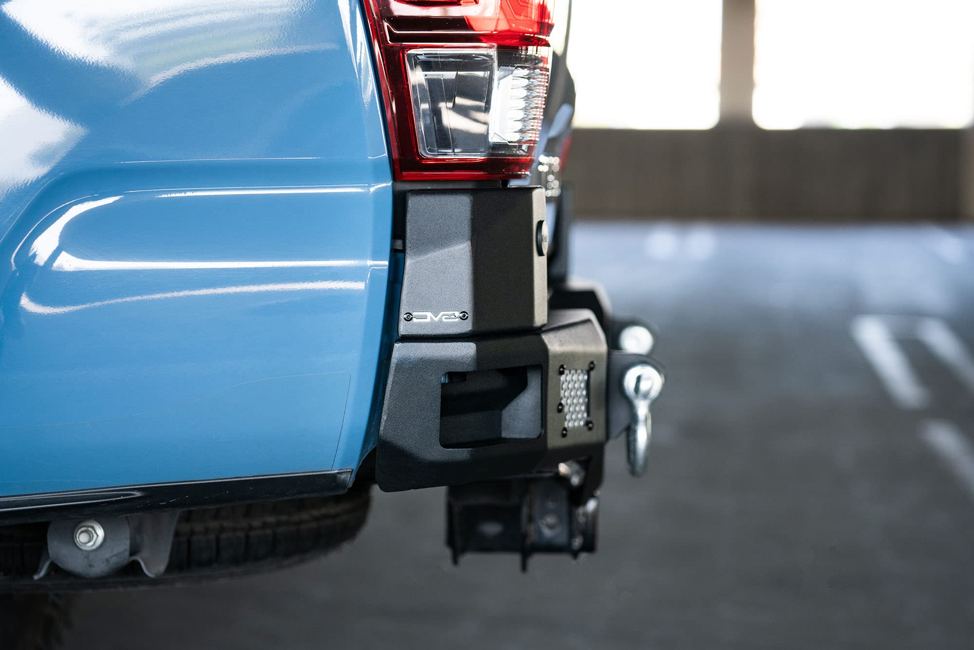 MTO Series Rear Bumper for Tacoma 2016 - Current | DV8 Offroad | Corner Side Steps | Auxiliary Light Mounts | Paintable Mesh Panels | Works with Sensors | Compatible with OEM Tow Package | RBTT1-04