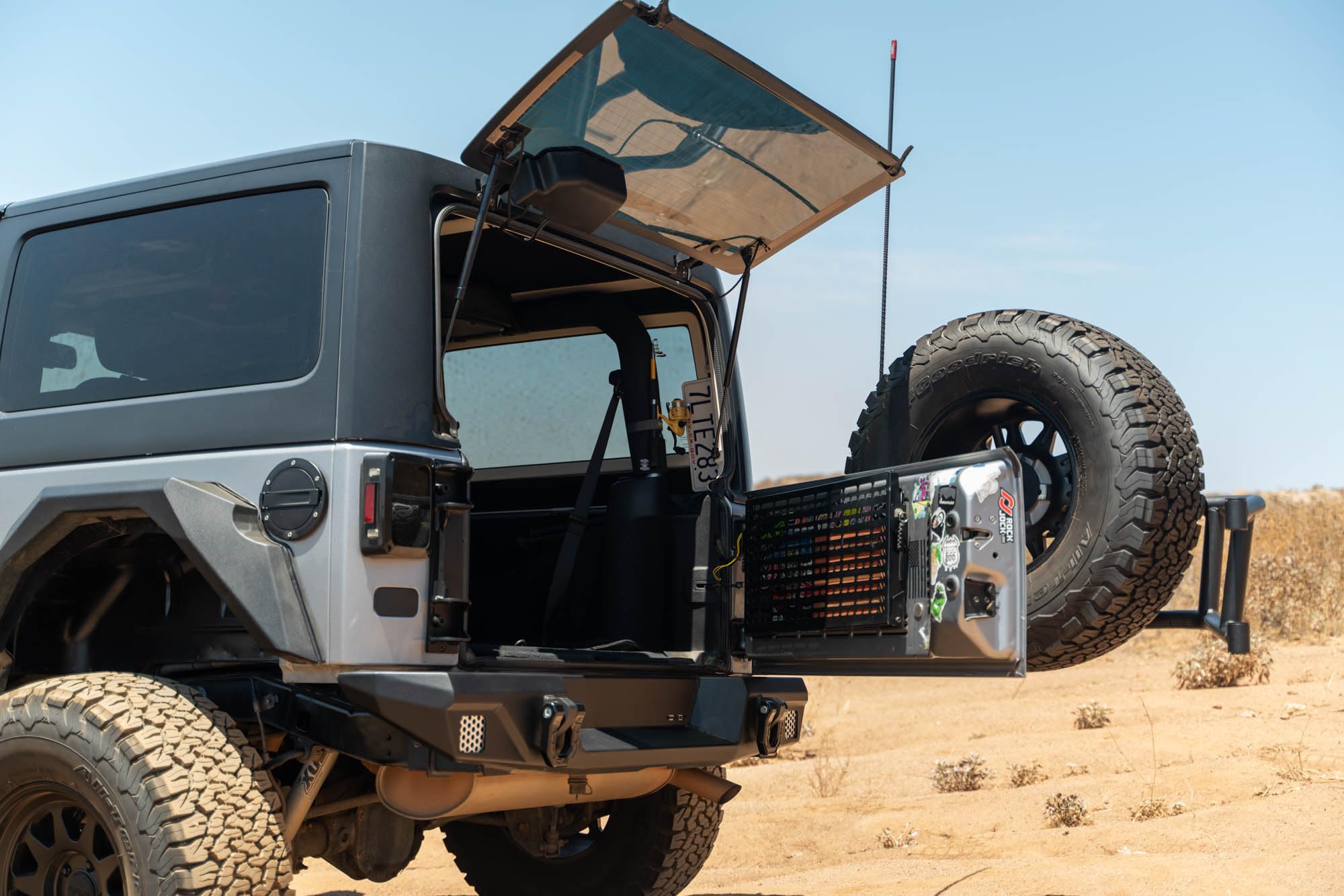 Tire Carrier Body Mounted for 2007-2018 Jeep Wrangler JK | Improves Departure Angle | Transfers Weight from The Door Hinges to The Vehicle Body | LED License Plate Light | 2 Whip Flag/Antenna Mounts