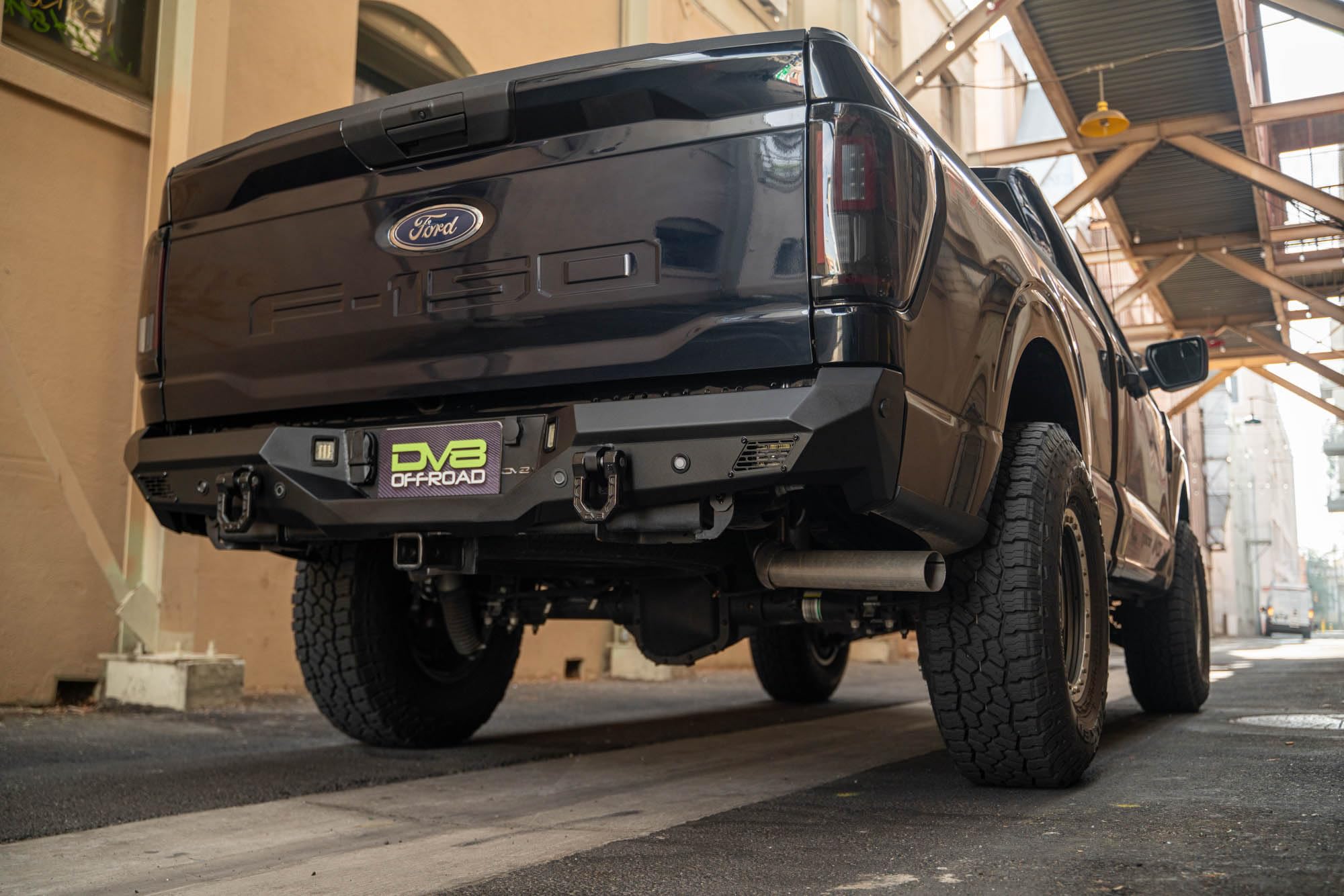 Rear Bumper DV8 Offroad Spec Series for 2021-2025 Ford F-150 | Full-Width Design | (2) 3" Pod Light Mounts | Pair of 1" D-Ring Mounts | Micro-Texture Black Powder Coat Finish | Steel Construction