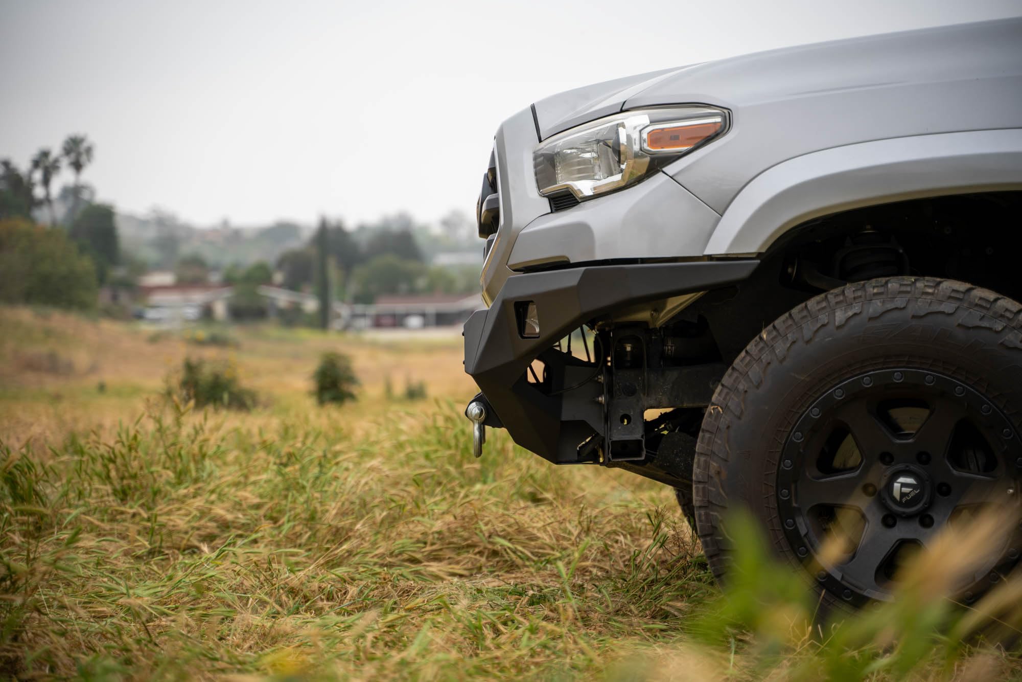 Winch Front Bumper DV8 MTO Series for 2016-2023 Toyota Tacoma | High Clearance Fitment | Mounts up to a 12,000lb Rated Winch | Integrated Light Bar and Pod Light Mounts | Black Powder Coat Finish