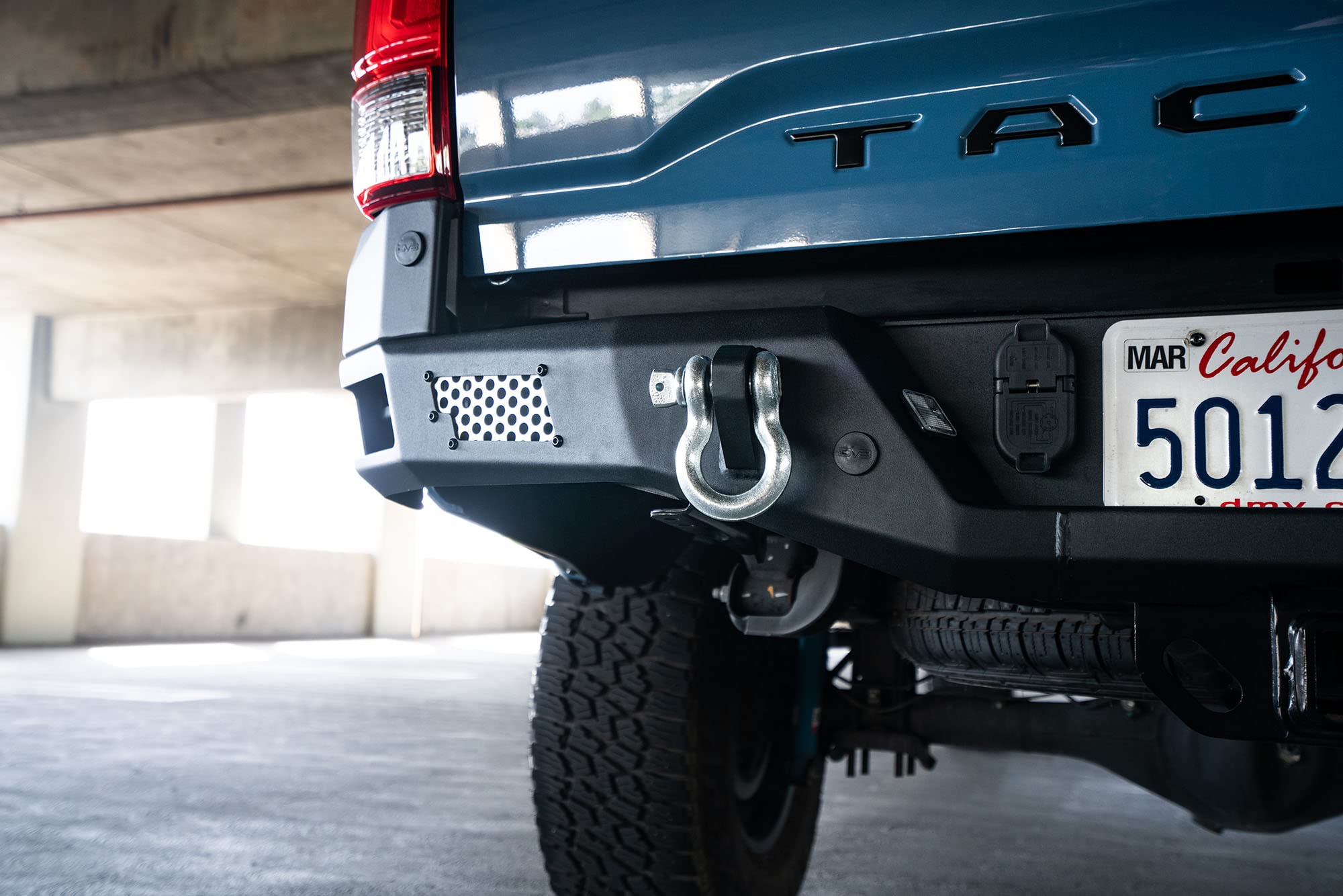 MTO Series Rear Bumper for Tacoma 2016 - Current | DV8 Offroad | Corner Side Steps | Auxiliary Light Mounts | Paintable Mesh Panels | Works with Sensors | Compatible with OEM Tow Package | RBTT1-04