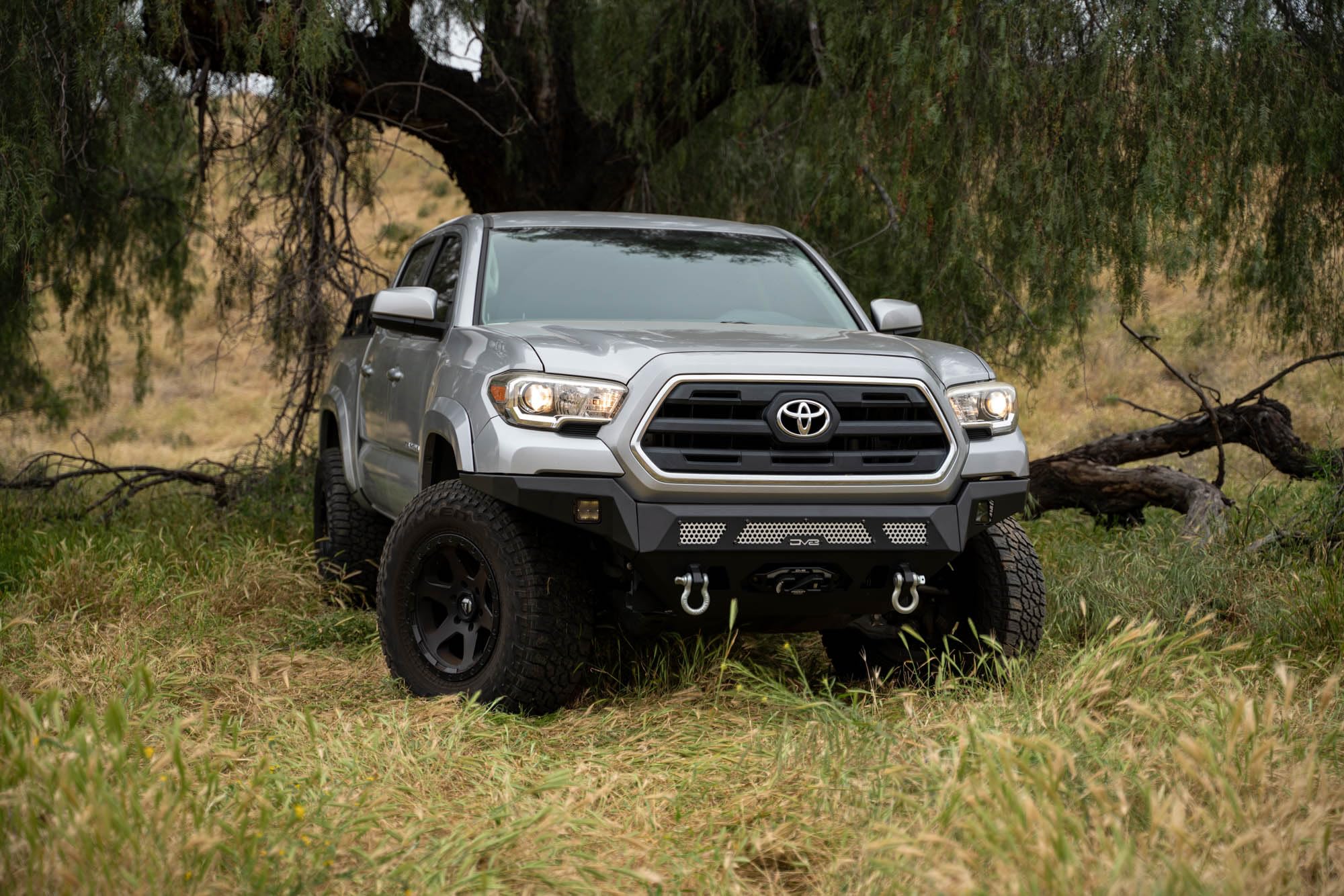 Winch Front Bumper DV8 MTO Series for 2016-2023 Toyota Tacoma | High Clearance Fitment | Mounts up to a 12,000lb Rated Winch | Integrated Light Bar and Pod Light Mounts | Black Powder Coat Finish