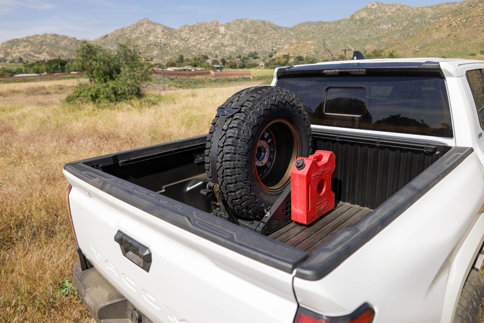 Offroad DV8 Truck Bed Universal Tire Carrier & Accessory Mount | Featured Side Molle Panels for Mounting Gear & Supplies | Adjustable for Carrying Various Sized Tires and Bikes | Powder Coated Finish
