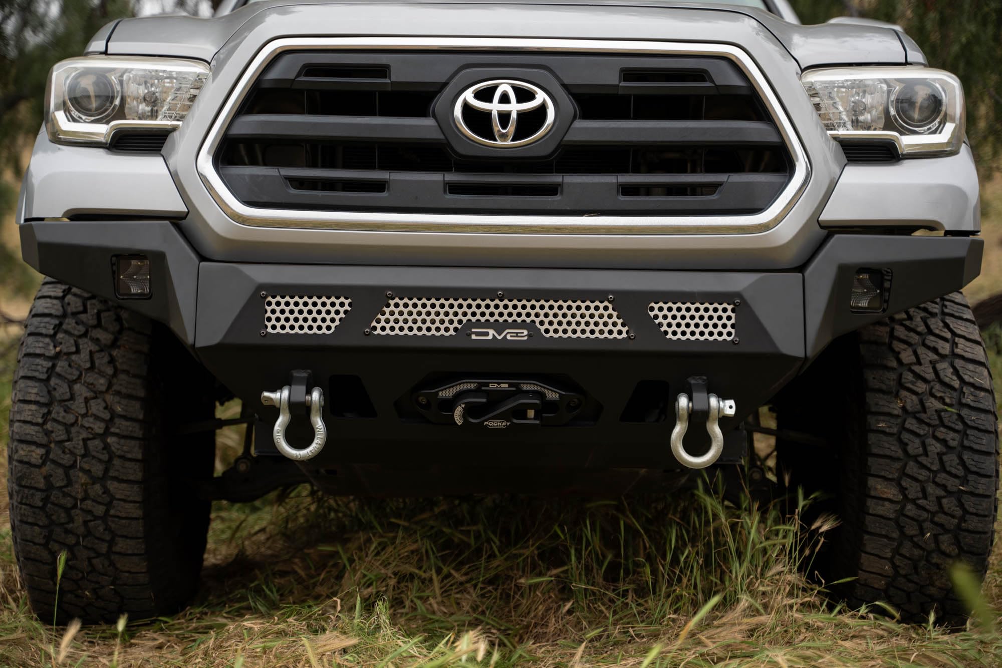 Winch Front Bumper DV8 MTO Series for 2016-2023 Toyota Tacoma | High Clearance Fitment | Mounts up to a 12,000lb Rated Winch | Integrated Light Bar and Pod Light Mounts | Black Powder Coat Finish
