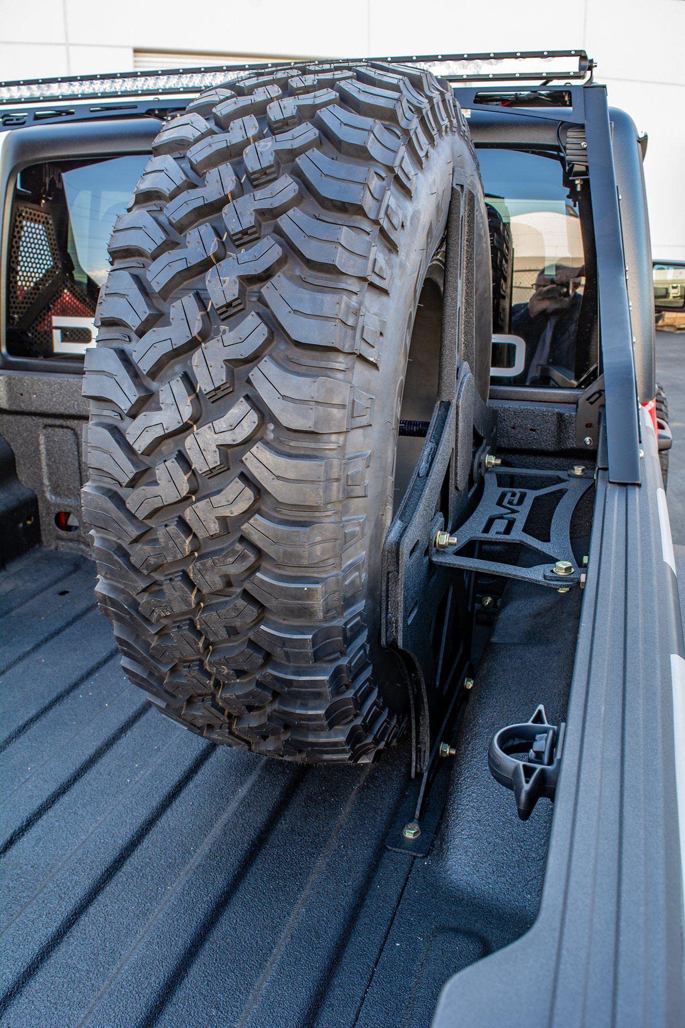 Spare Tire Mount DV8 Offroad for The 2020-2025 Jeep Gladiator JT | Vertical in-Bed Design | Accommodates up to 42" Tire | Mounts Either Bed Rail | Powder Coat Finish