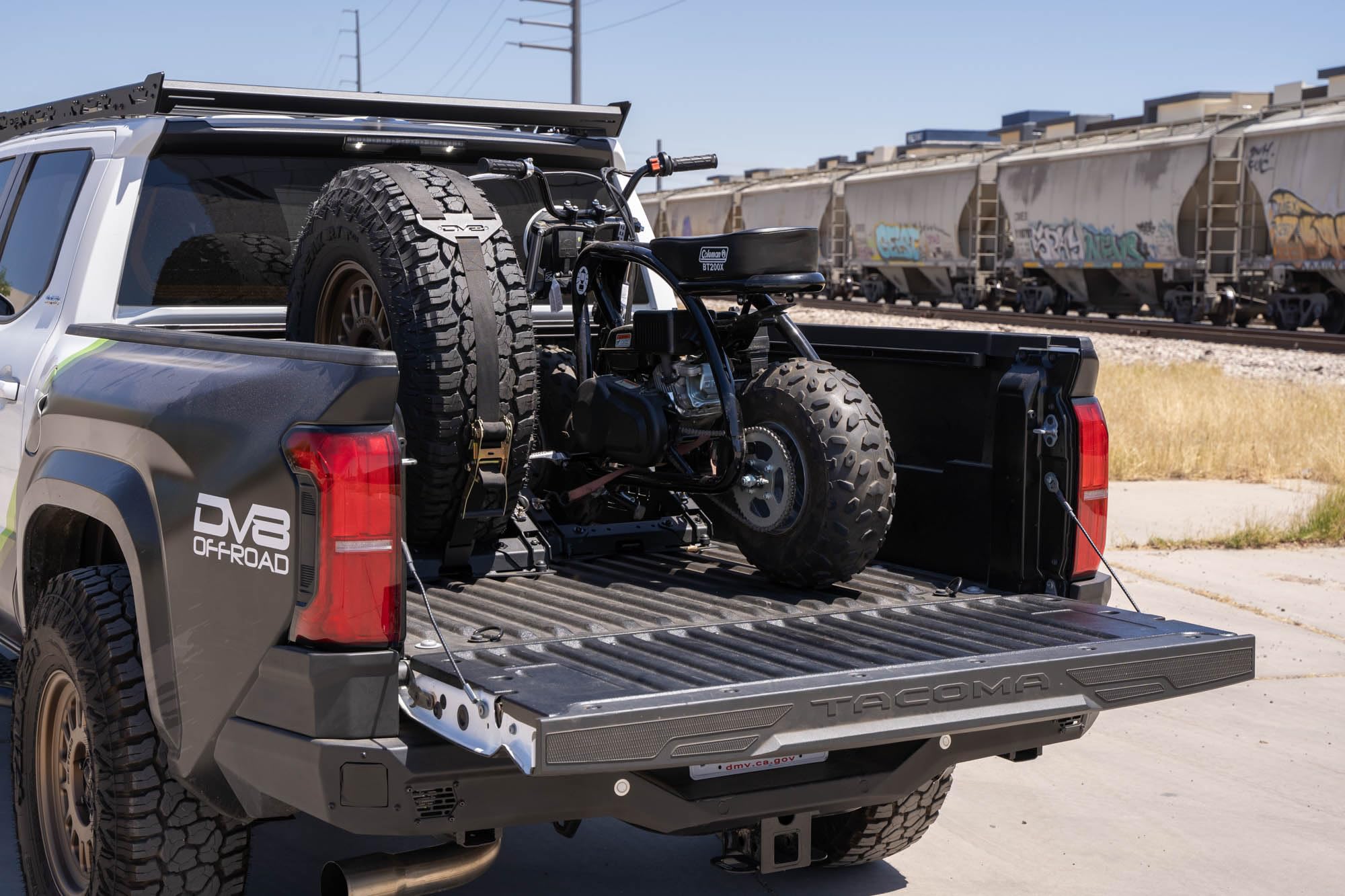 Offroad DV8 Truck Bed Universal Tire Carrier & Accessory Mount | Featured Side Molle Panels for Mounting Gear & Supplies | Adjustable for Carrying Various Sized Tires and Bikes | Powder Coated Finish