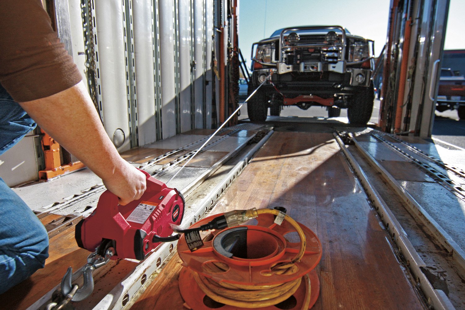 PullzAll WARN 885005 Cordless 24V DC Portable Electric Winch with Steel Cable and 2 Rechargeable Battery Packs: 1/2 Ton (1,000 lb) Pulling Capacity, red