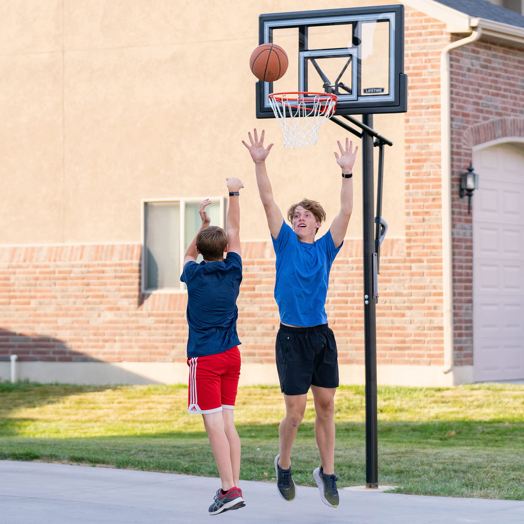 Lifetime Basketball Hoop Adjustable In-Ground, Action Grip Height Adjustment 7.5-10 Ft, 50-Inch Shatterproof Fusion Backboard, Slam-It Rim, Powder-Coated Steel Pole