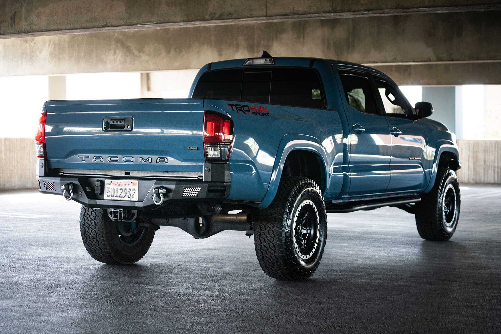 MTO Series Rear Bumper for Tacoma 2016 - Current | DV8 Offroad | Corner Side Steps | Auxiliary Light Mounts | Paintable Mesh Panels | Works with Sensors | Compatible with OEM Tow Package | RBTT1-04