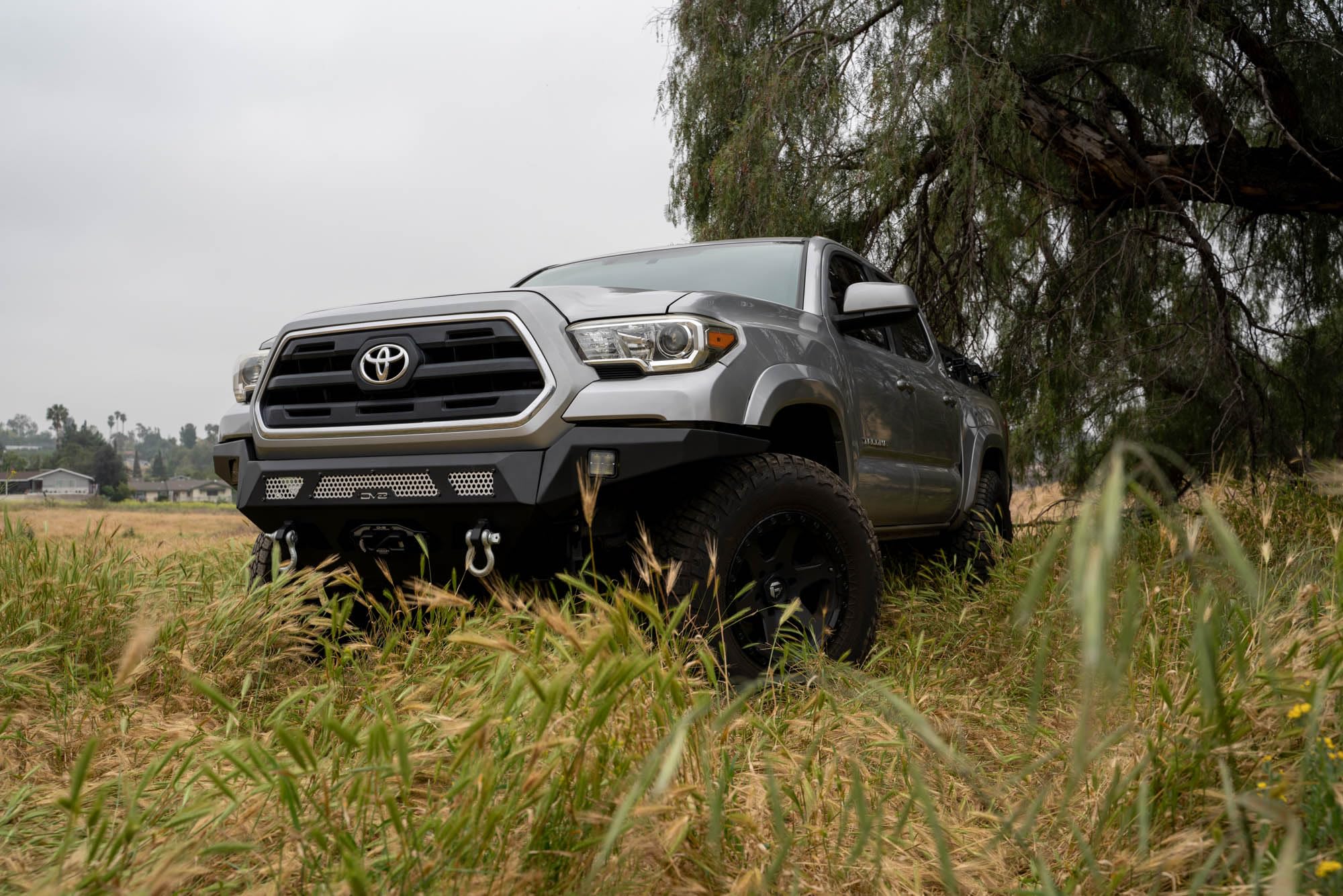 Winch Front Bumper DV8 MTO Series for 2016-2023 Toyota Tacoma | High Clearance Fitment | Mounts up to a 12,000lb Rated Winch | Integrated Light Bar and Pod Light Mounts | Black Powder Coat Finish