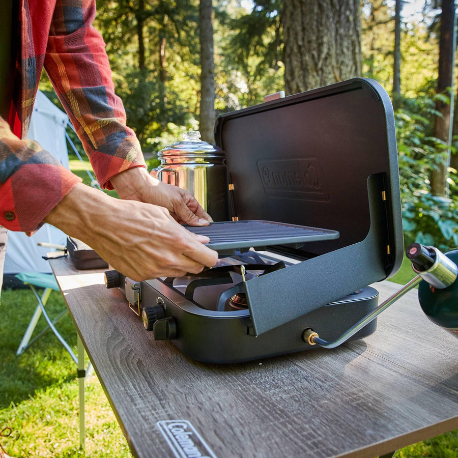 Coleman 3-in-1 Propane Camping Stove 1900 Collection, Cast Iron Grill & Griddle Accessories Included, 24,000 BTUs Across 2 Adjustable Burners with Wind Guards & Matchless Lighting