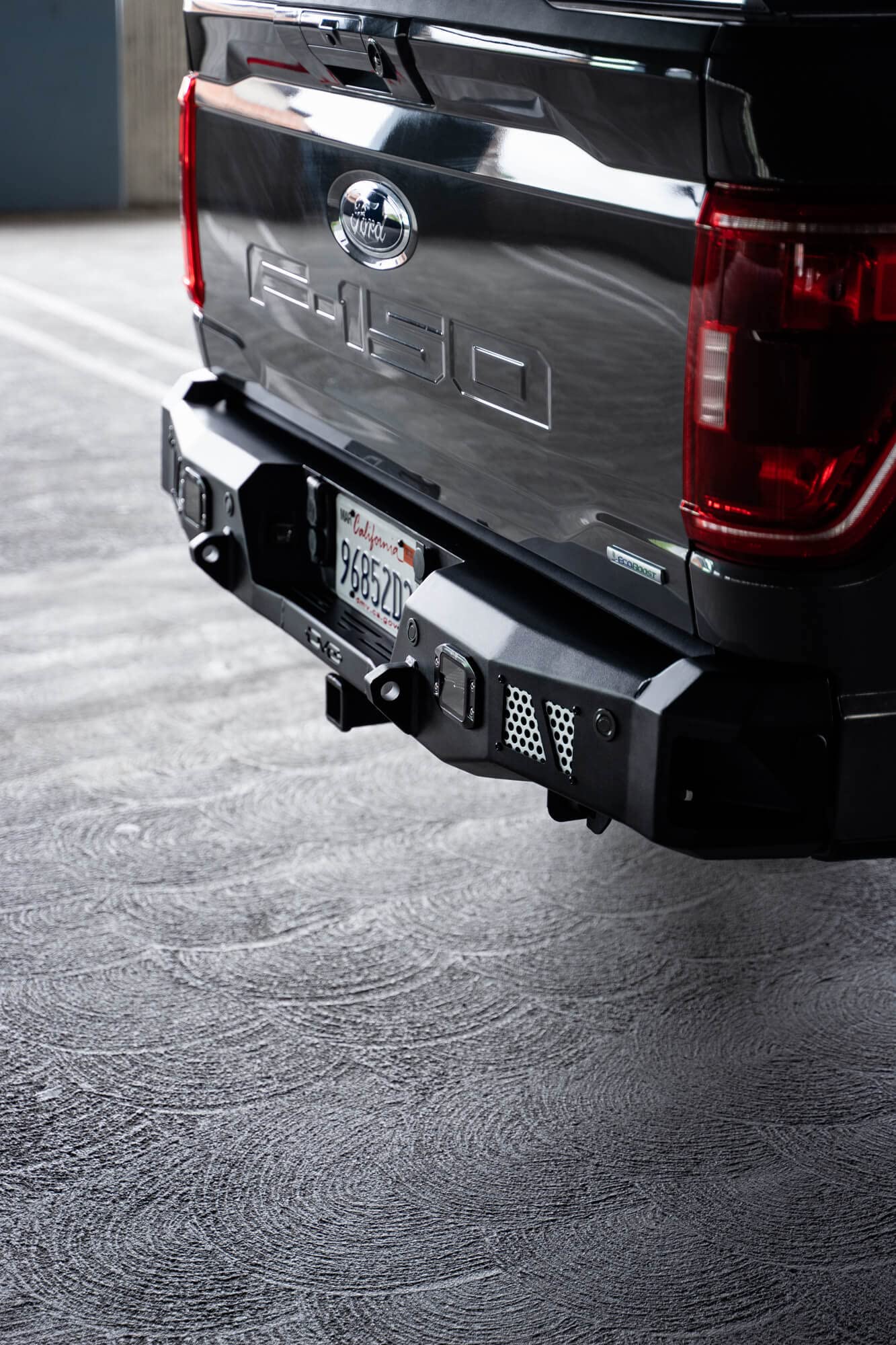 MTO Series DV8 Offroad Rear Bumper for 2021-2025 Ford F-150 | Utility Steps | Designed for Single Exhaust Setups | Accepts (2) 3" Flush Mount Pod Lights | Paintable Aluminum Inserts