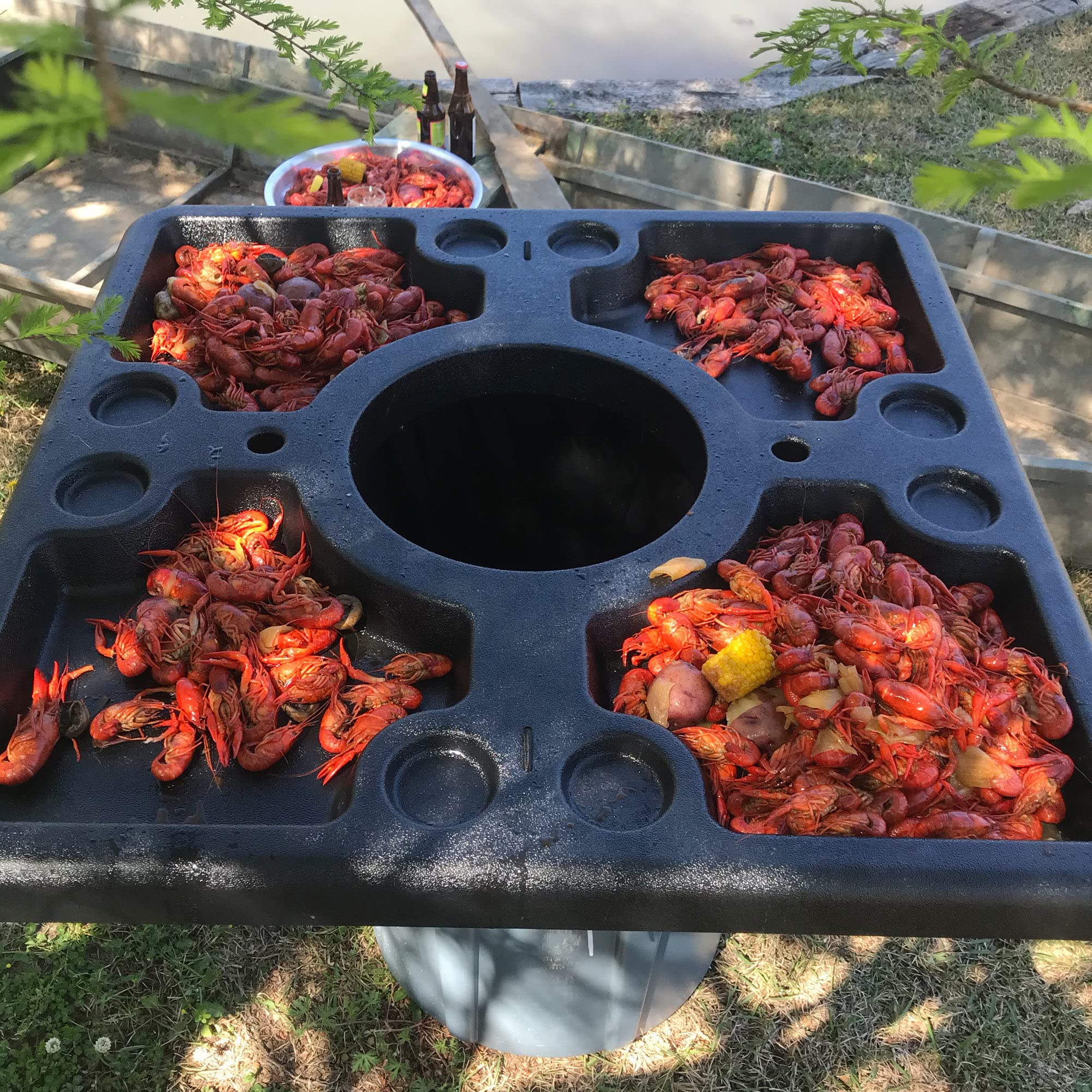 300-444 Bayou Classic Seafood Crawfish Event Table Features 4 Large Serving Areas and 8 Beverage Holders 40-in x 40-in Fits Most Standard Garbage Cans & Secures w/ 2 Bungee Cords Lightweight Portable